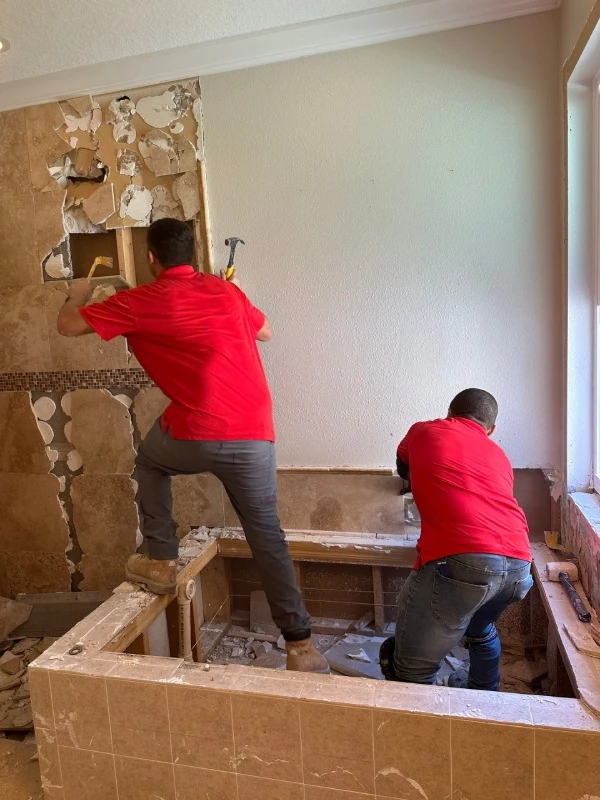 Red Eagle team in action during a bathroom demolition phase — start your renovation with a Free Flooring Quote and expert guidance.