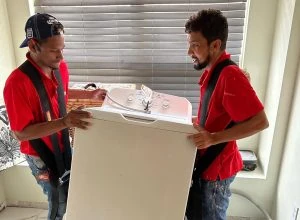 Red Eagle Flooring team transporting a vanity during preparation for flooring installation services