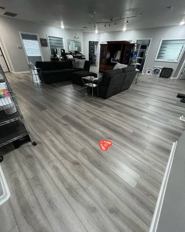 Modern gray-toned vinyl plank flooring in a stylish open living area — request your Free Flooring Quote from Red Eagle Flooring