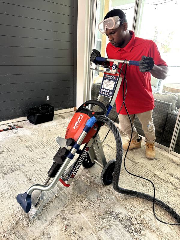 Floor removal in progress using professional equipment — Red Eagle Flooring offers clean demolition services with a Free Flooring Quote.