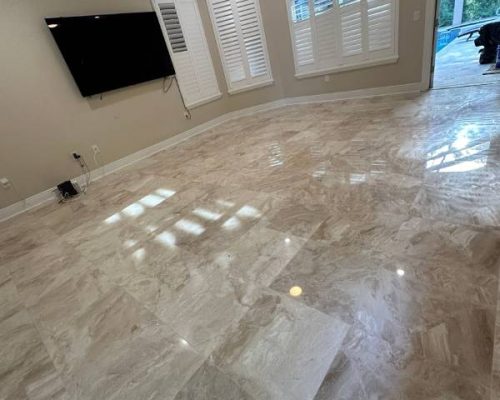 Shiny porcelain tile flooring reflecting natural light in a large living area — explore this finish and get your Free Flooring Quote today.