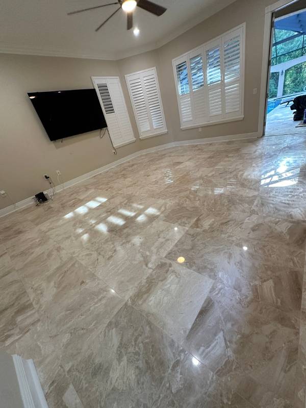 Shiny porcelain tile flooring reflecting natural light in a large living area — explore this finish and get your Free Flooring Quote today.