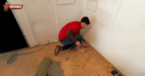 Technician removing carpet padding during a Flooring Renovation project
