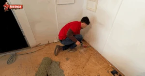 Technician removing carpet padding during a Flooring Renovation project