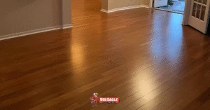 Gleaming hardwood Florida flooring in a warm English Chestnut finish, professionally installed by Red Eagle Flooring, enhancing a home interior.