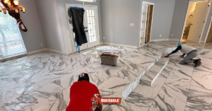 Red Eagle Flooring team installing beautiful faux marble Florida flooring, showcasing expert tile work in a spacious room.