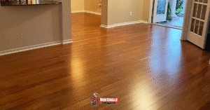 A residential living area featuring warm-toned, glossy hardwood flooring, showcasing a pet-friendly flooring option that combines beauty and durability for homes with pets.