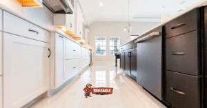 Modern kitchen with high-gloss tile Kitchen and Bathroom Flooring, featuring contrasting white and dark cabinetry to create a spacious, reflective look.
