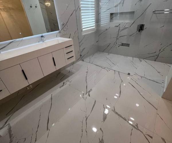 Remodeled bathroom with white design and porcelain tile — premium flooring installation service by Red Eagle Flooring