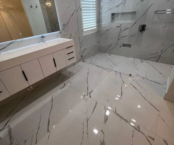 Remodeled bathroom with white design and porcelain tile — premium flooring installation service by Red Eagle Flooring