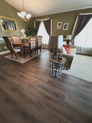 Dining and living area featuring dark hardwood-style floors — premium flooring installation service for elegant interiors