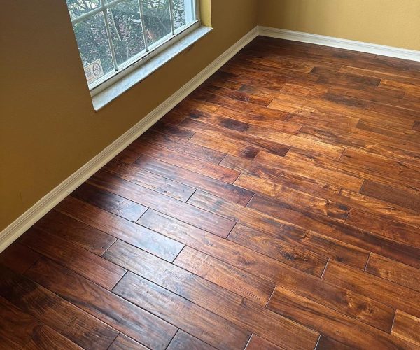 Hand-scraped hardwood flooring in a cozy sunlit room — transform your space with a Free Flooring Quote.