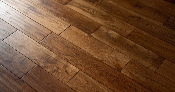 Rich, dark hardwood floors with natural grain details, adding depth and warmth.