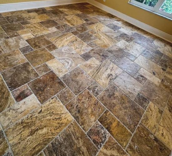 Rustic brown tile floor completed by Red Eagle’s flooring installation services, showcasing natural texture and pattern